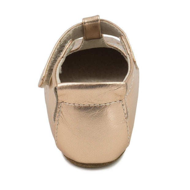 Baby shoe in metallic rose gold leather back view