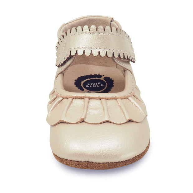 Adorable champagne colored baby shoe with ruffle toe, front view