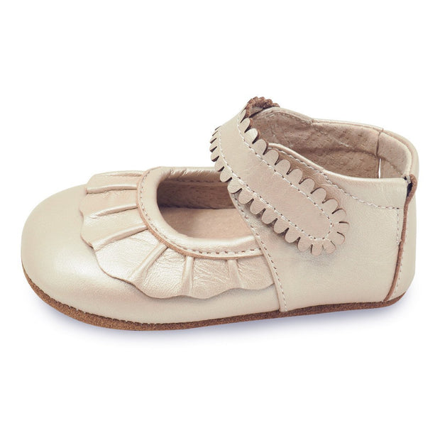 Adorable champagne colored baby shoe with ruffle toe, side view